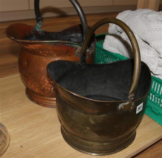 A copper coal scuttle and a brass coal scuttle